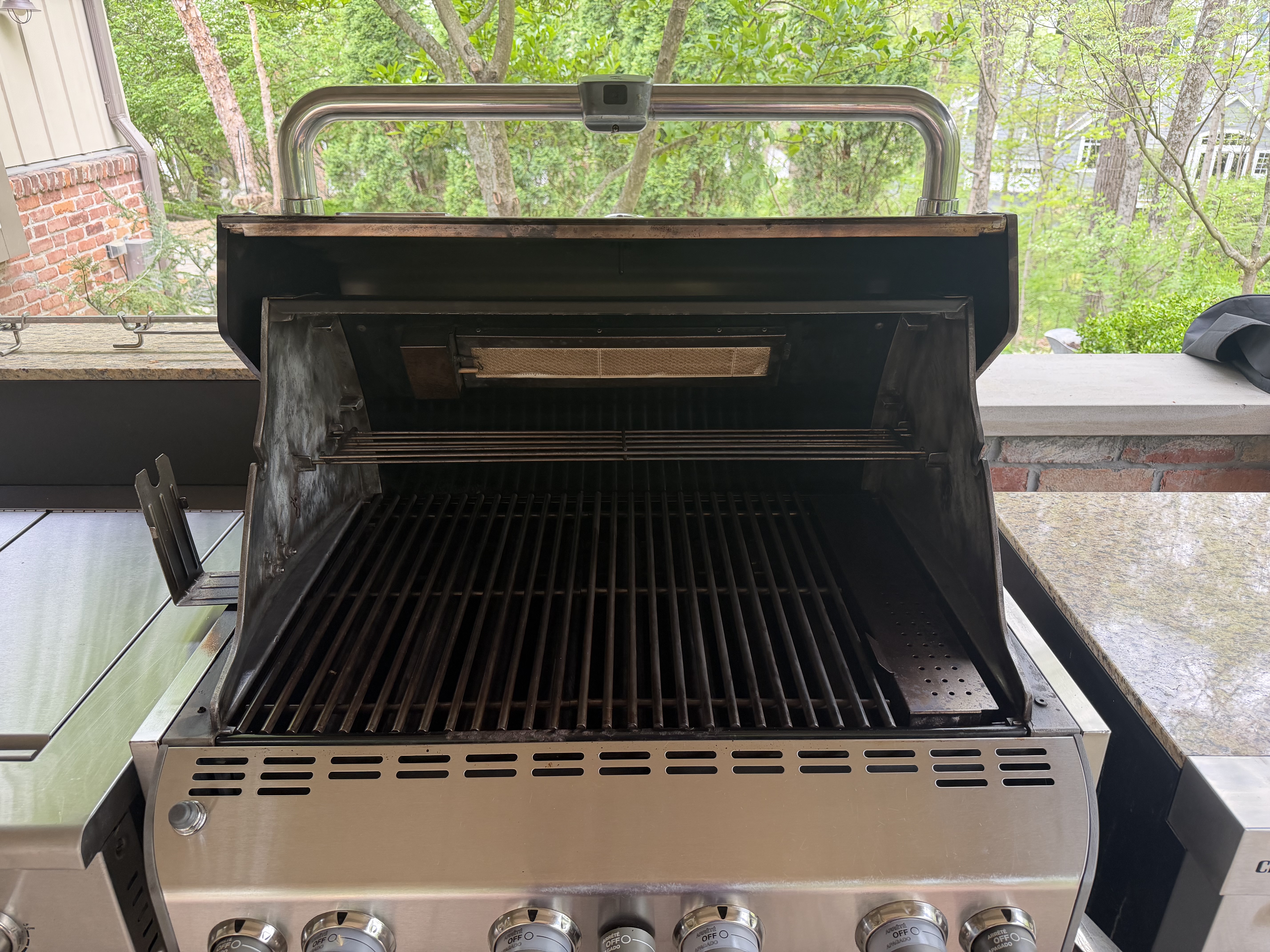 After: the same 5-burner gas grill with a clean cookbox interior and fresh grates